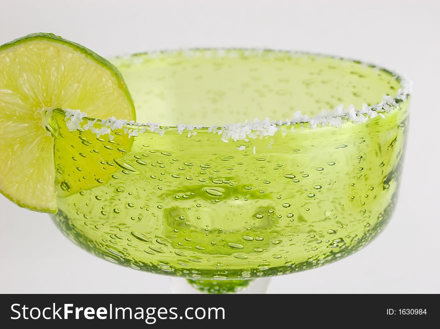 Margarita glass with a lime slice and salted rim. Margarita glass with a lime slice and salted rim