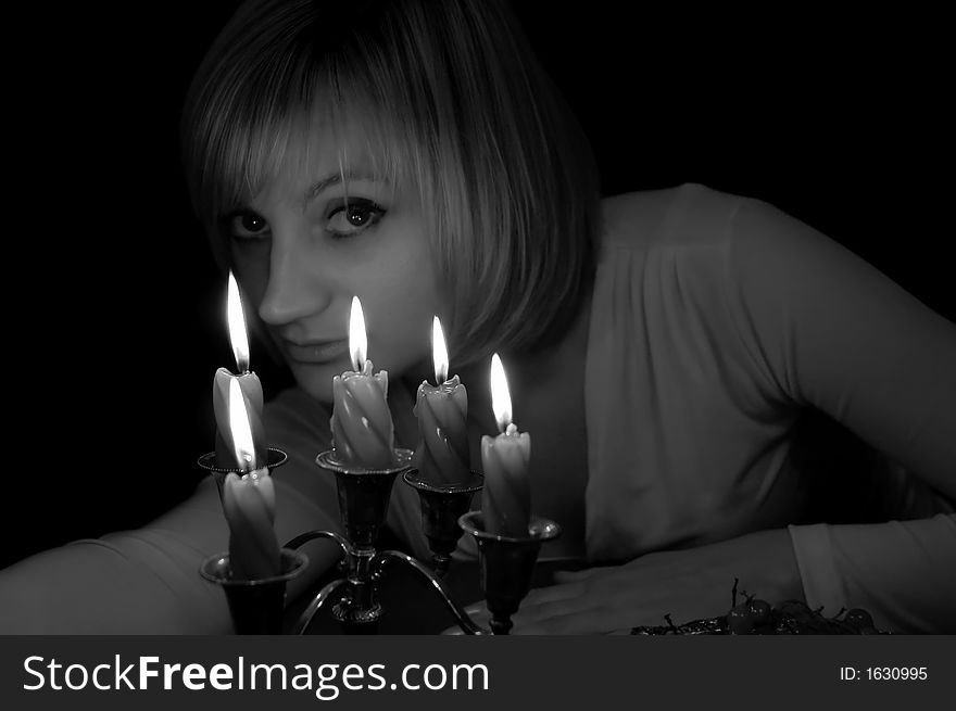The girl and burning candles. The girl and burning candles