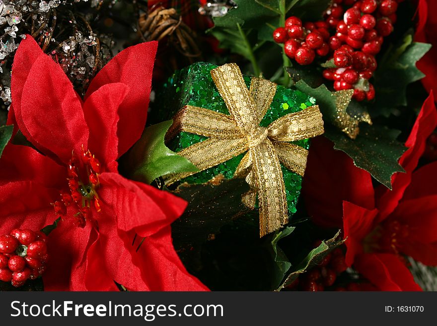 Christmas basket with greenery, berries, holly, and wrapped presents isolated on white space. Christmas basket with greenery, berries, holly, and wrapped presents isolated on white space