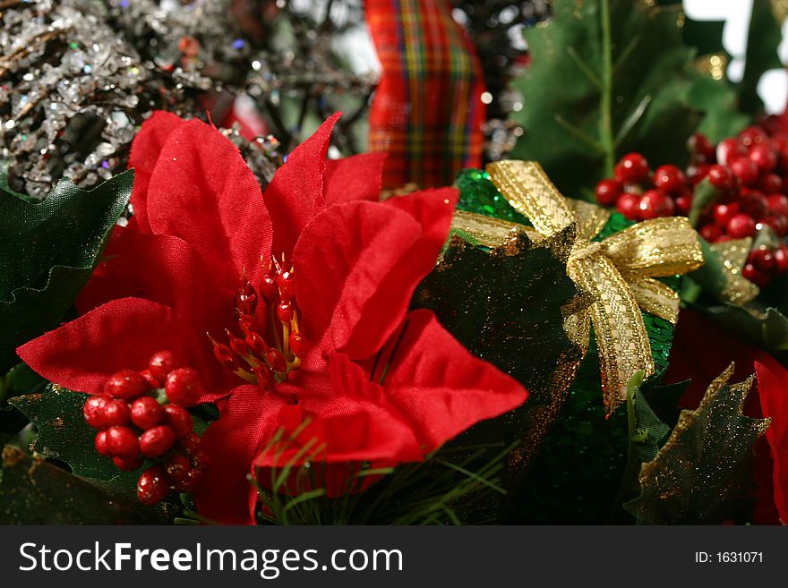 Christmas basket with greenery, berries, holly, and wrapped presents isolated on white space. Christmas basket with greenery, berries, holly, and wrapped presents isolated on white space