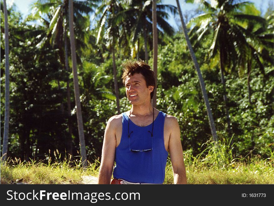 Smiling man gazes at the scenery on a Hawaiian trail. Smiling man gazes at the scenery on a Hawaiian trail.