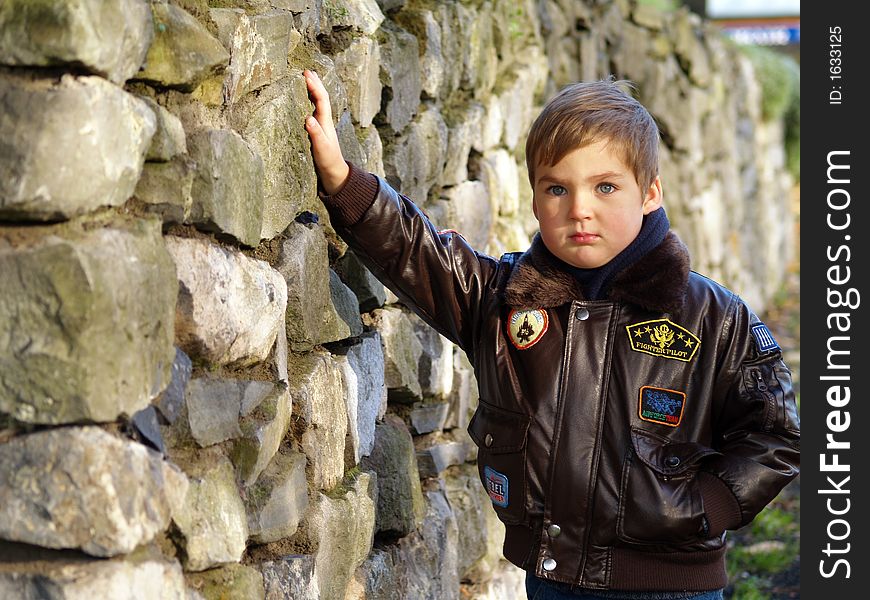 Boy standing on the stones wall