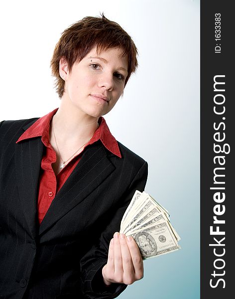 Serious woman in business attire holding some cash. Serious woman in business attire holding some cash