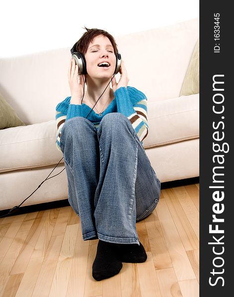 Cute girl with headphone happy lying on the couch. Cute girl with headphone happy lying on the couch