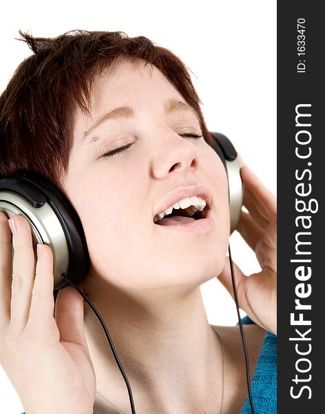 Woman holding headphones and singing. Woman holding headphones and singing