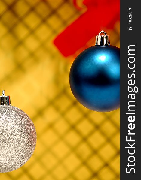 Silver and blue Christmas ornaments on the yellow beckground