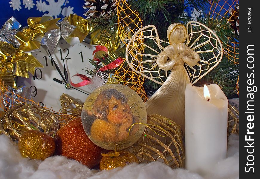 Christmas - New Year composition with wicker angel figure, Christmas tree toys, candle, clock. Christmas - New Year composition with wicker angel figure, Christmas tree toys, candle, clock
