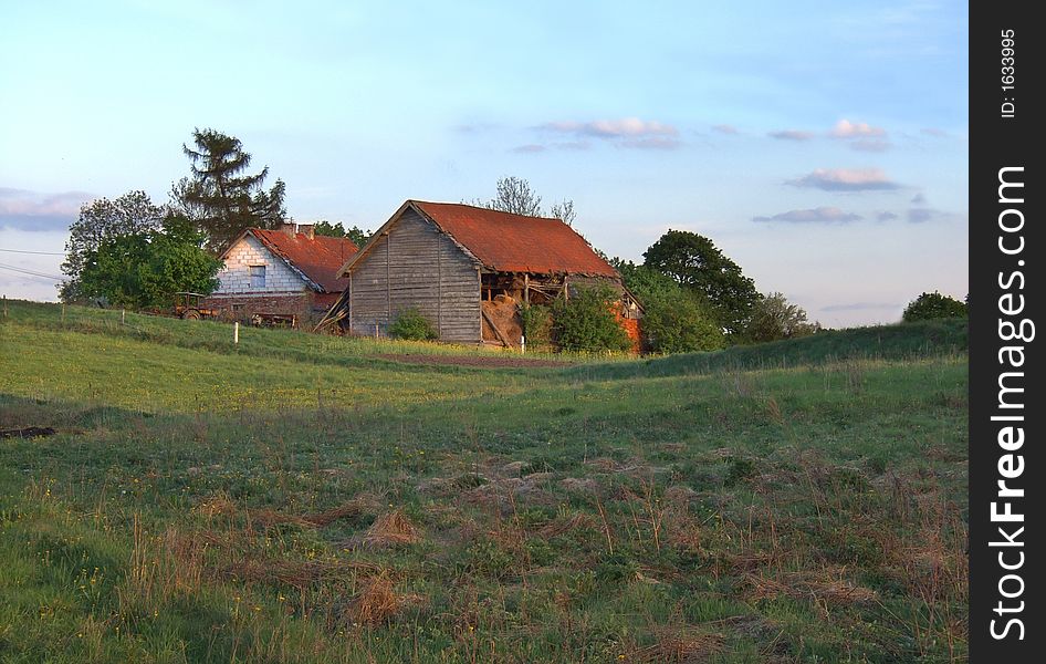 Evening spring landscape with old farm