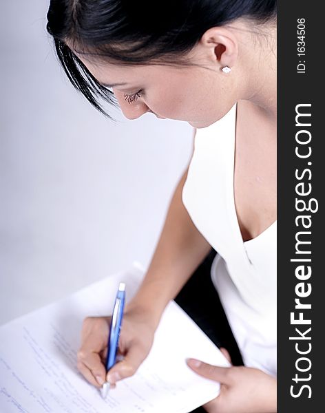 Picture of woman handwriting notes with blue pen. Picture of woman handwriting notes with blue pen.