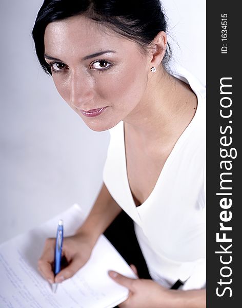 Picture of woman handwriting notes with blue pen. Picture of woman handwriting notes with blue pen.