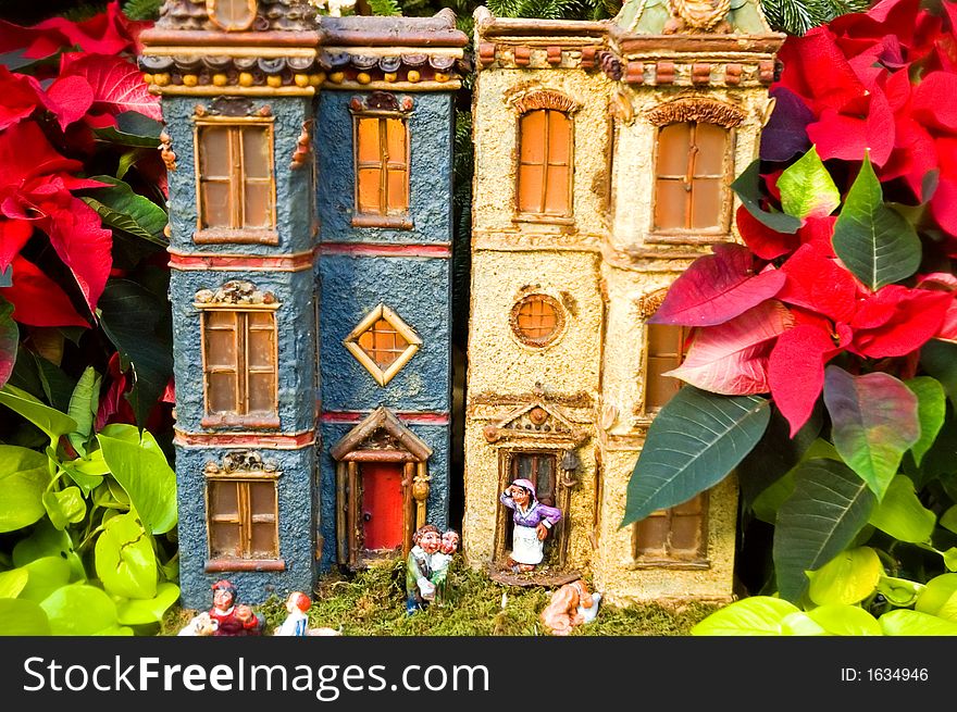 Two houses in a toy village in a forest of red poinsettias at the National Botanical Gardens, Washington, DC. Two houses in a toy village in a forest of red poinsettias at the National Botanical Gardens, Washington, DC