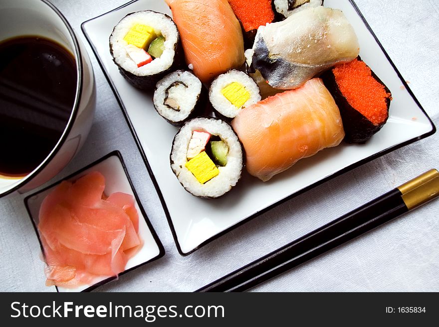 Sushi settings: maki-suhi, unagi-sushi, sushi with caviar of flying fish, chops, plates, soya sauce, ginger. Sushi settings: maki-suhi, unagi-sushi, sushi with caviar of flying fish, chops, plates, soya sauce, ginger