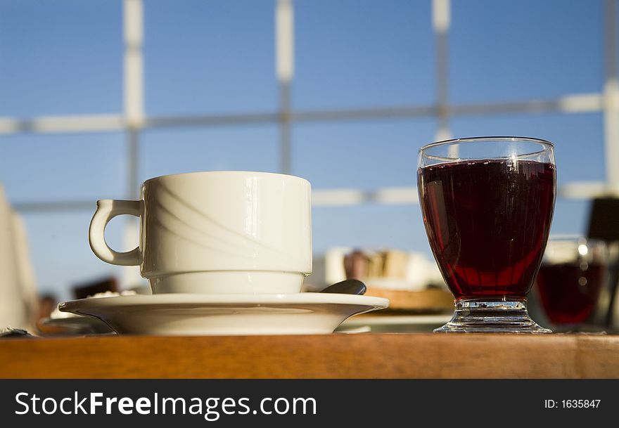 A cup and a glass on a background of the light-blue sky