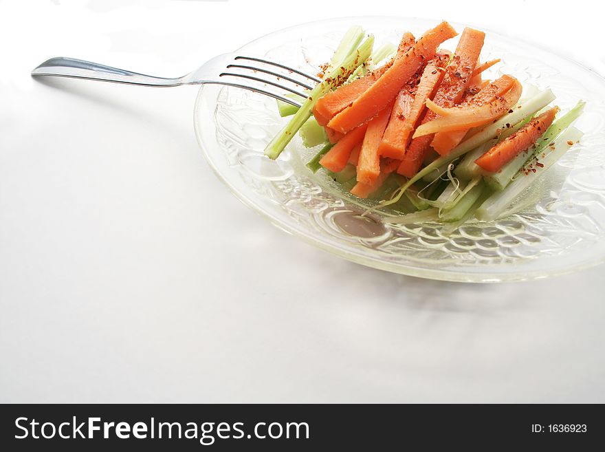 Carrot and celery salad over white background