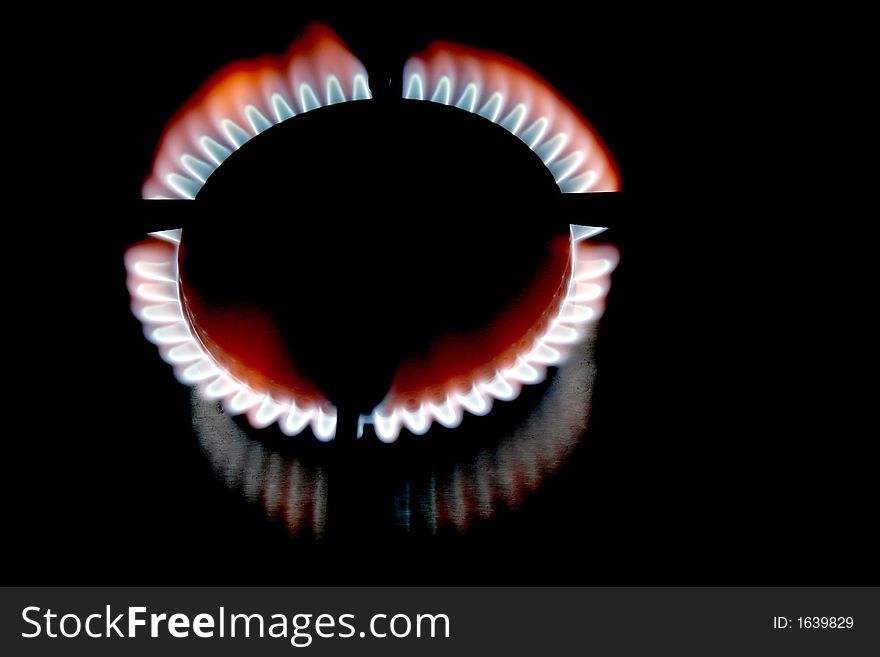 Blue Flame Of A Stove Burner In Darkness Illustrating Combustion Of Gas. Blue Flame Of A Stove Burner In Darkness Illustrating Combustion Of Gas