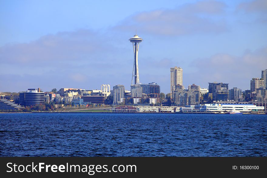 The Queen Anne district and the Seattle Space Needle tower from across the bay. The Queen Anne district and the Seattle Space Needle tower from across the bay.