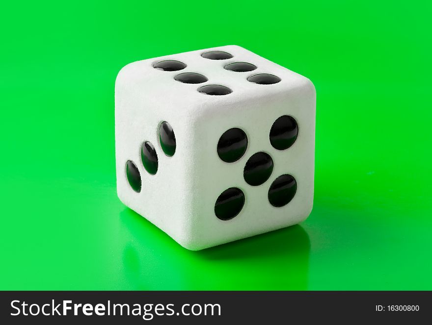 Gambling dice on green background