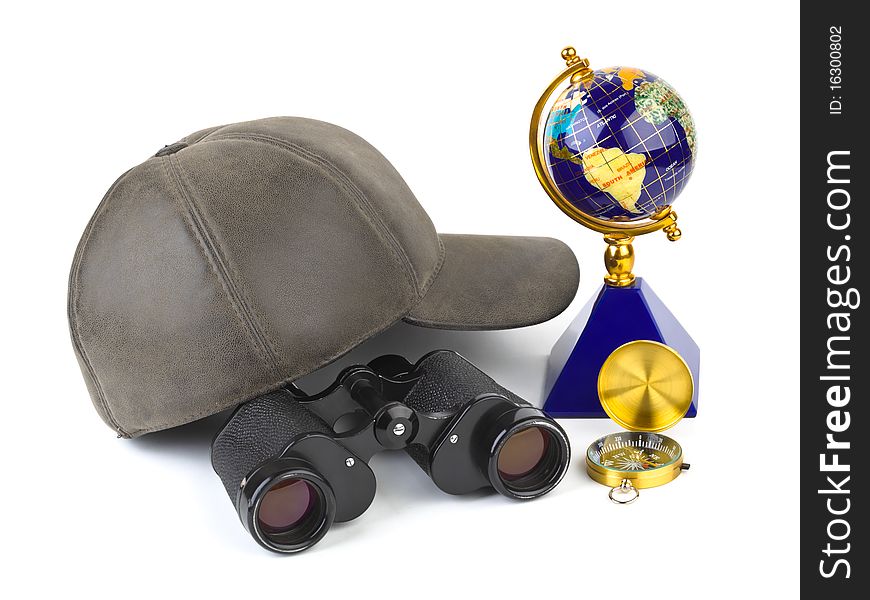 Binoculars, cap, compass and globe - travel concept