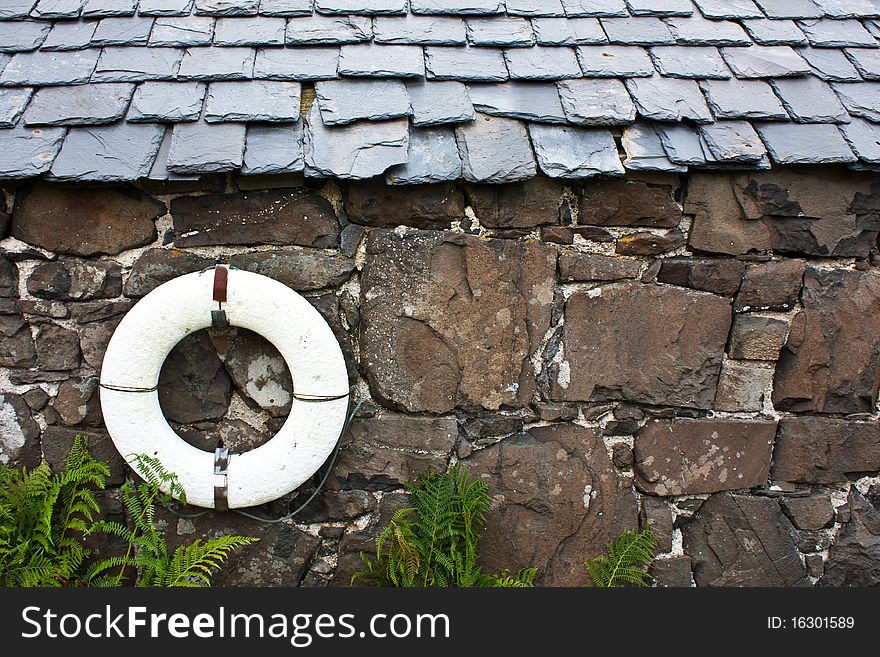 Life-preserver on a wall in a fishermen village - Scotland