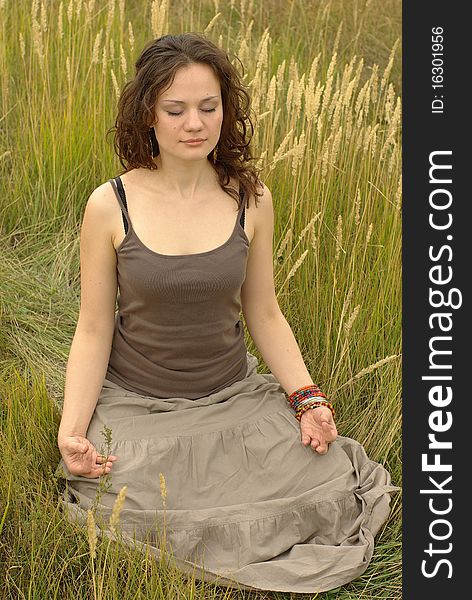 Girl meditating in the autumn field