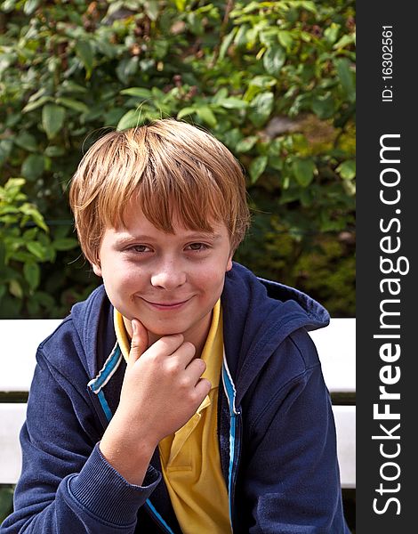 Boy sitting on a bench in a park