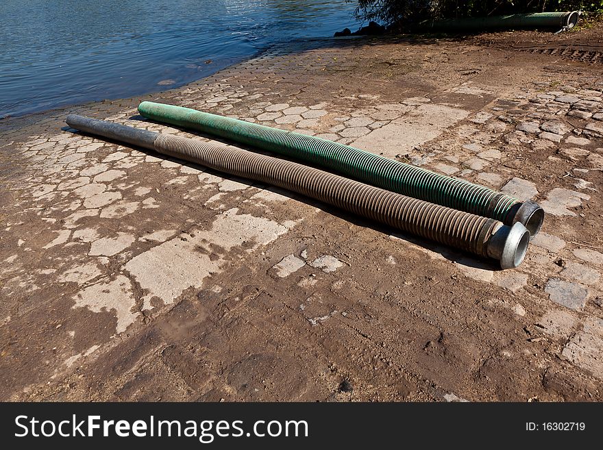 Flexible tubes for disposing liquid manure in the river. Flexible tubes for disposing liquid manure in the river