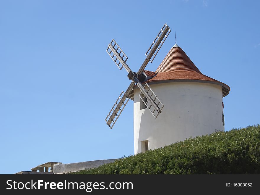 White windmill against blue sky located in Corsica island (Cap Corse)