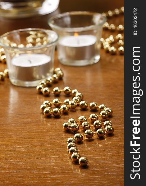 Gold background and candels on brown table