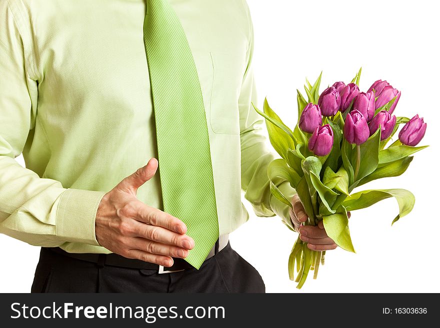 Young man in green shirt holding pink tulips. Young man in green shirt holding pink tulips