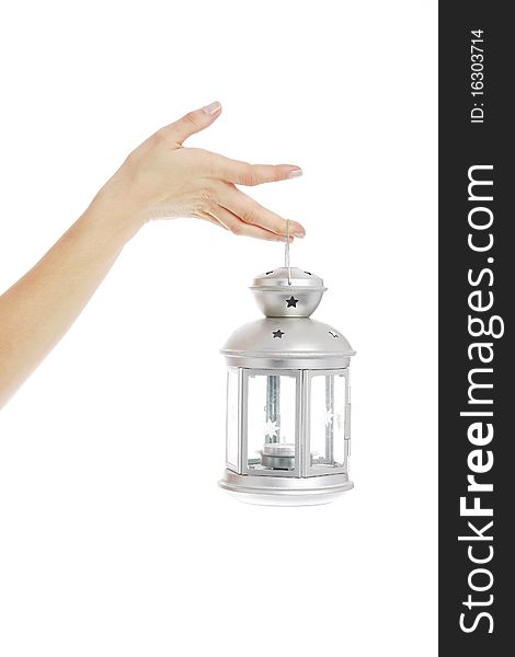 Hand holding a lantern in white background