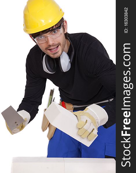 Happy bricklayer with stone and spade on white background