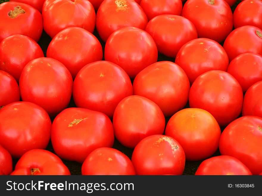 A ripe red tomatoe background. A ripe red tomatoe background