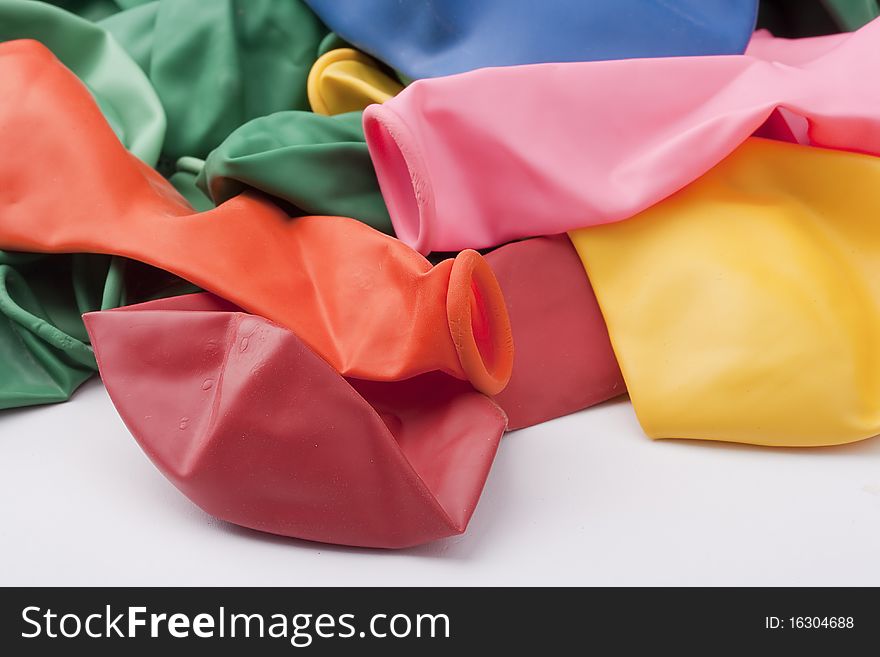 Inflatable balls of different colour from latex on a white background.