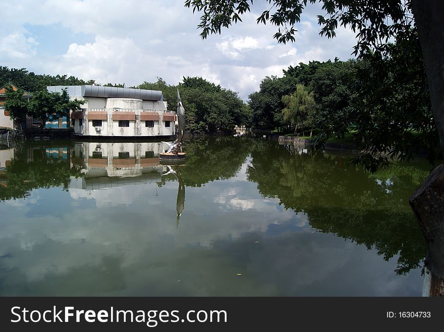 Lakes and buildings, and trees. Shade. Reflection in the water. Beautiful scenery. This is a part of the park in Shenzhen Xin. Lakes and buildings, and trees. Shade. Reflection in the water. Beautiful scenery. This is a part of the park in Shenzhen Xin.