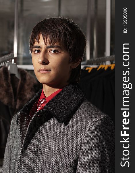 Portrait of a handsome young man of sixteen. Youth shows autumn, winter clothing. Portrait of a handsome young man of sixteen. Youth shows autumn, winter clothing.