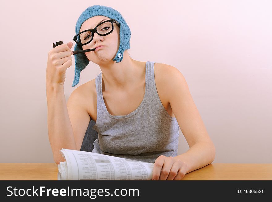 Young woman smoking pipe in studio.