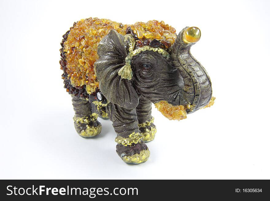Amber toy elephant on a white background