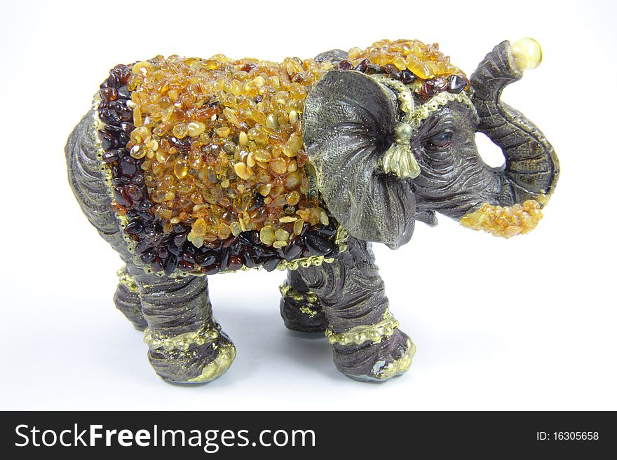 Amber toy elephant on a white background