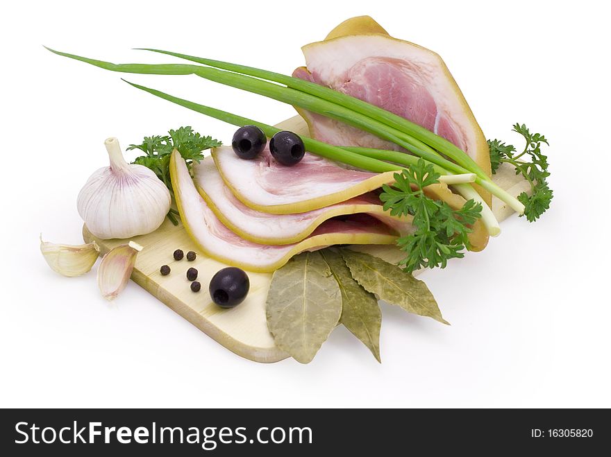 Nice fresh pink bacon with greens and spices isolated on white with clipping path. Nice fresh pink bacon with greens and spices isolated on white with clipping path