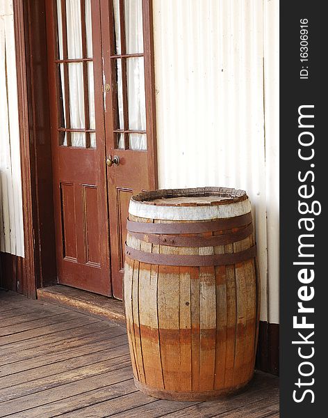 A barrel standing in front of a saloon