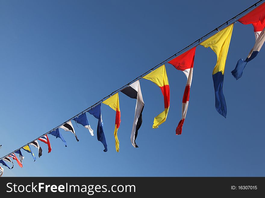 Colors flags on blue sky. Colors flags on blue sky