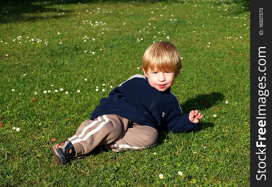 Boy lying on the grass in park