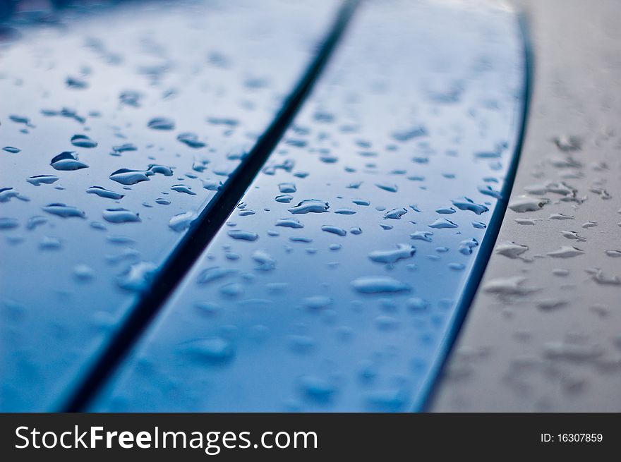 Whater drops on the surface of a blue car