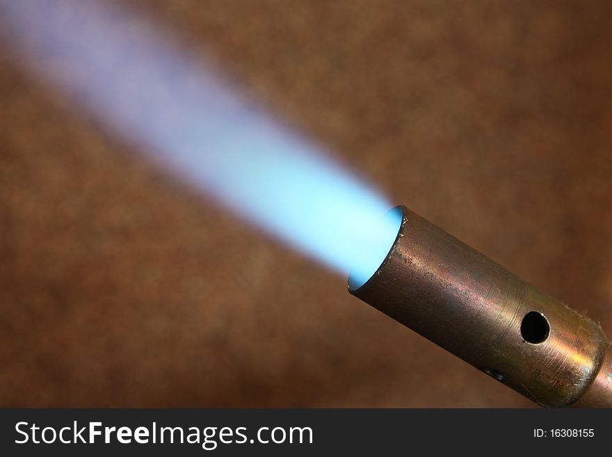 Blue flame on brown background. Blue flame on brown background.