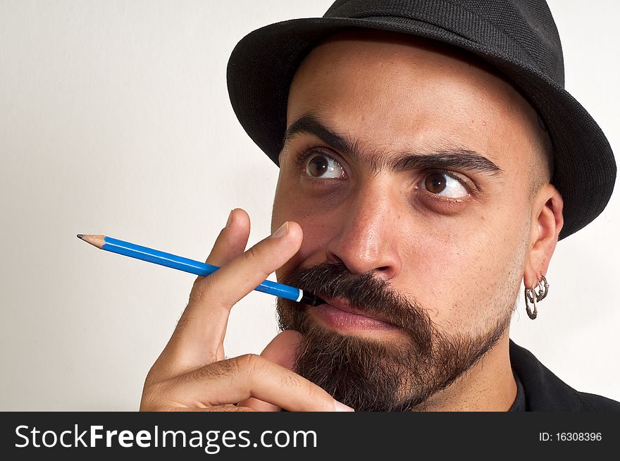 Man with a pencil and a hat with funny expression with white background