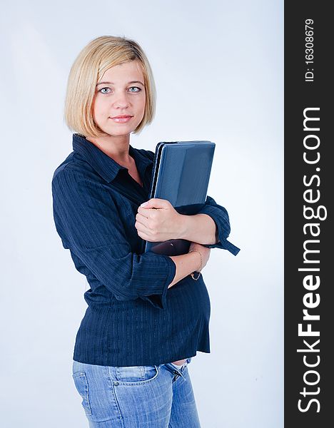 Sweet pregnant girl with a laptop in the studio