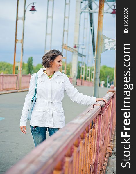 Beautiful young woman having fun in the autumn walk