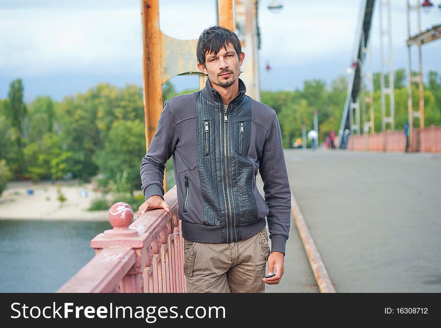 Portrait of a young beautiful man on autumn walk