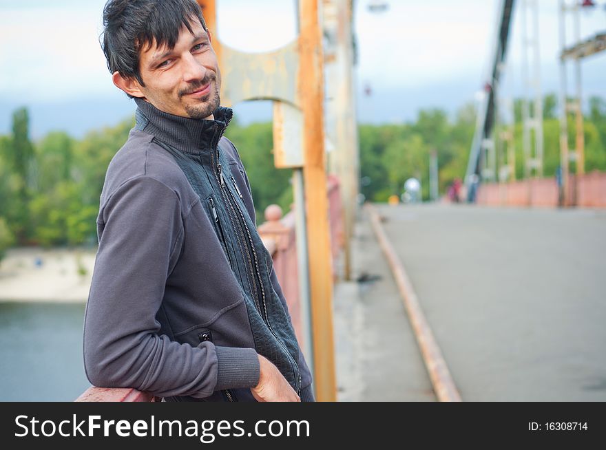 Portrait of a young beautiful man on autumn walk