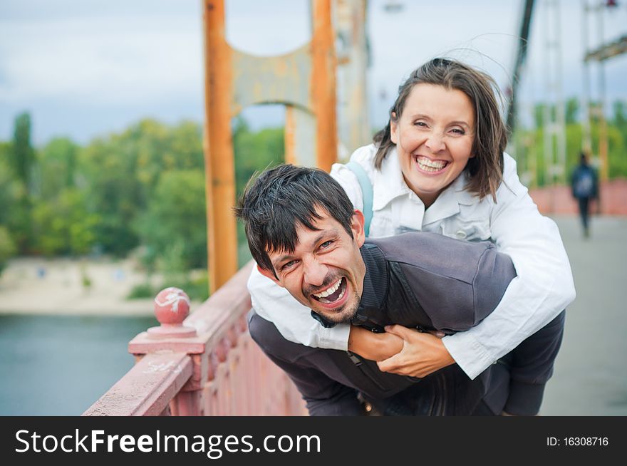 Young beautiful couple having fun in the autumn walk